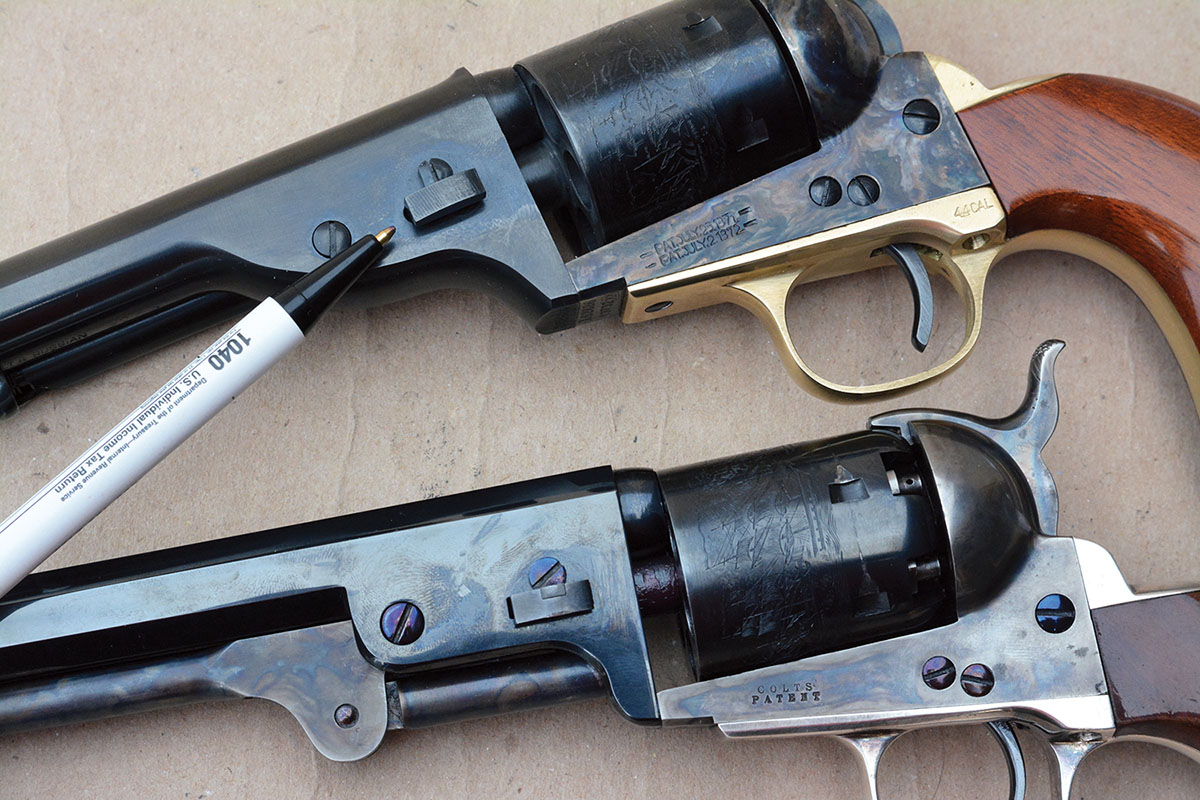 The Cimarron 1872 Open Top (top) features a wedge that secures the barrel to the frame,  similar to the cap-and-ball Colt Model 1851  Navy (bottom).